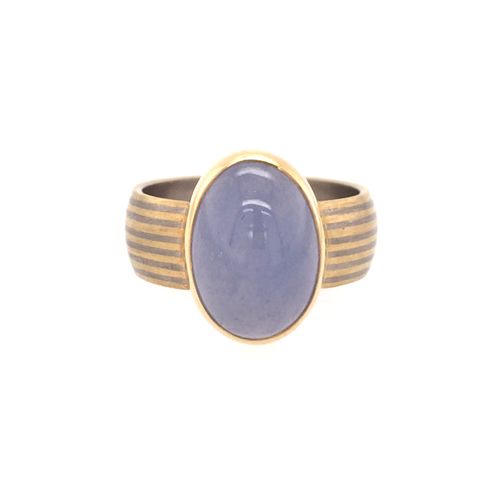 Ring with oval chalcedony cabochon bezel-set in a hand fabricated 18k grey gold band.