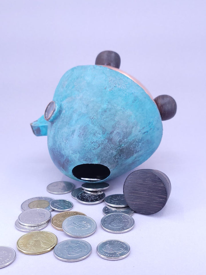 Happy Teapot Piggy Bank - A smiling teapot-shaped piggy bank of cheerful blue patinated copper, with copper and glass googly eyes. 