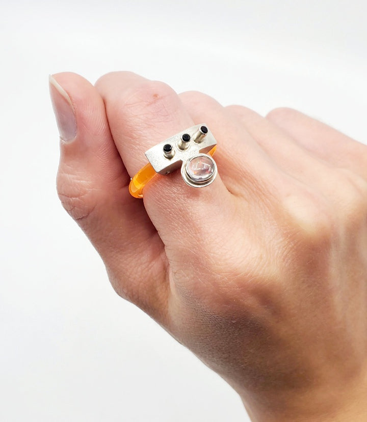 Anna Lindsay MacDonald Laika Doublet, in flouro orange, perfect for ring stacking, set with opal cabochon and three black spinels. Hand fabricated in sterling silver. 