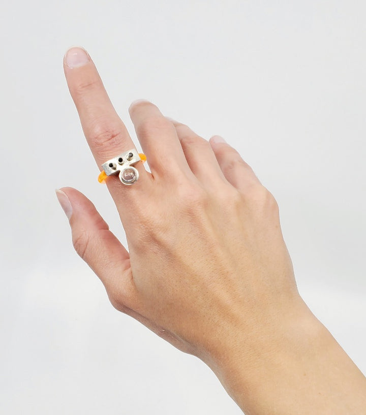 Anna Lindsay MacDonald Laika Doublet, in flouro orange, perfect for ring stacking, set with opal cabochon and three black spinels. Hand fabricated in sterling silver. 