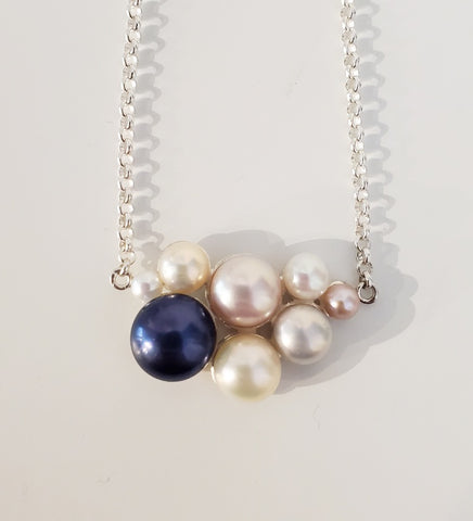 Annie Tung Blush pendant, horizontal placement of freshwater button pearls in sterling silver, with a fine chain. The backing of each pearl is itself beautiful, the shape reminiscent of a flower or sanddollar.