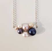 Annie Tung Blush pendant, horizontal placement of freshwater button pearls in sterling silver, with a fine chain. The backing of each pearl is itself beautiful, the shape reminiscent of a flower or sanddollar.