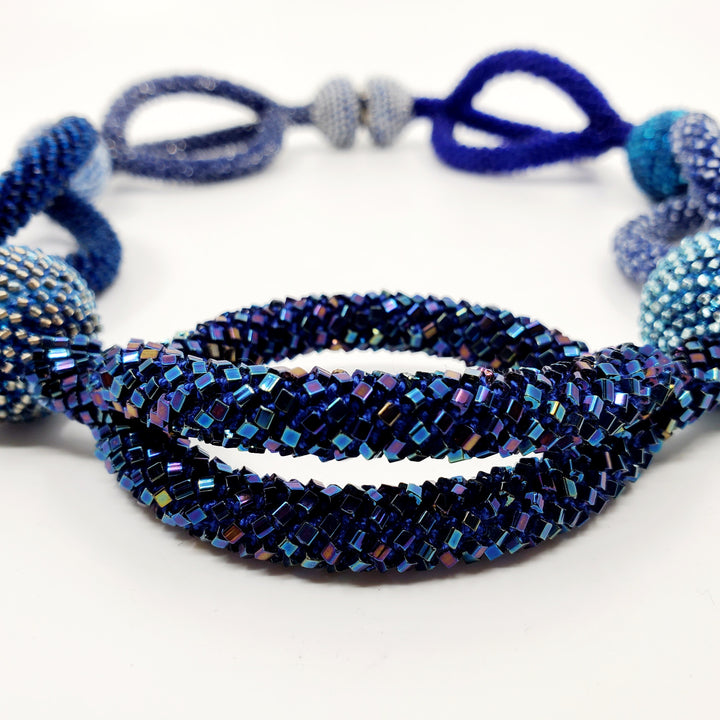 Yael Krakowski Multilayered Blue Leaves Necklace with glass beads, aluminum and thread.