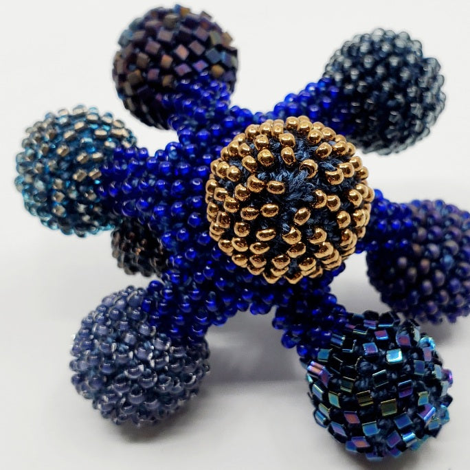 Yael Krakowski Blue Flower Ring with glass beads, and thread.