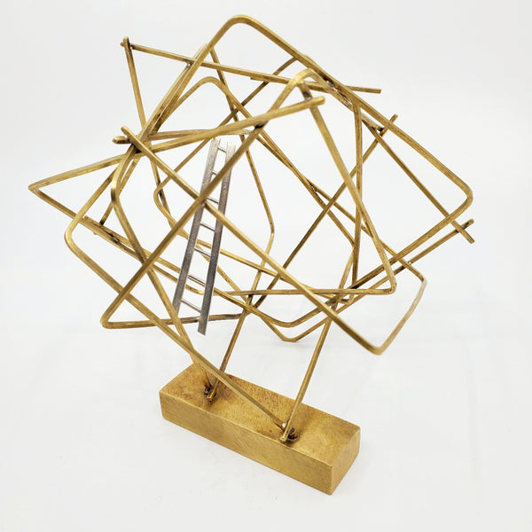 "Getting Here" - Brass cubic sculpture with a sterling silver ladder rising up from a single attachment point. This precious small sculpture is well anchored on a weighty solid brass base. 