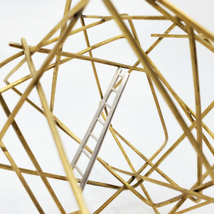 "Getting Here" - Brass cubic sculpture with a sterling silver ladder rising up from a single attachment point. This precious small sculpture is well anchored on a weighty solid brass base. 