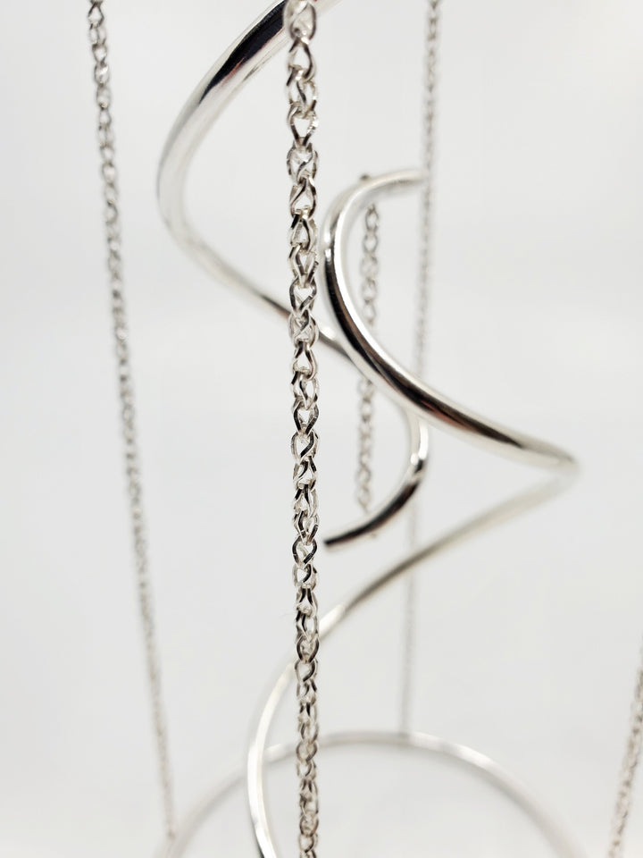 Tensegrity - A kinetic, collapsible, sculpture of sterling silver, with sapphires. 