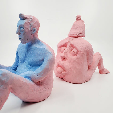 Kiss Me Baby II- small double-sided pink and blue ceramic sculpture painted with gouache. The sculpture is comprised of two sides, one of a figure and the other of a face. - WIth its counterpart