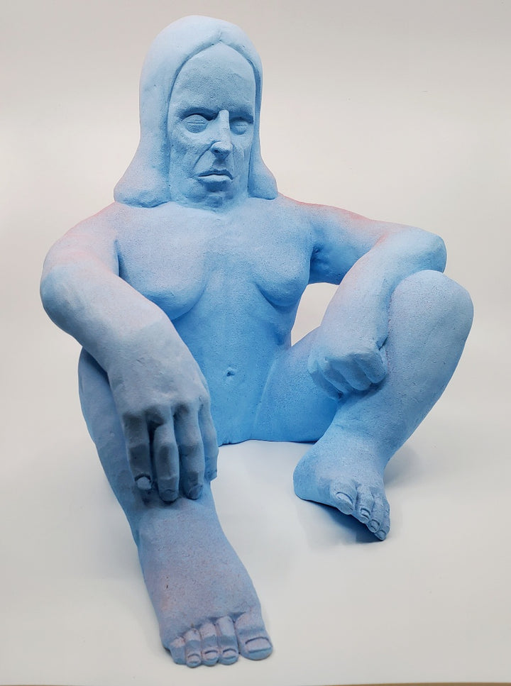 Holding Back II - large ceramic two-sided sculpture of a figure biting a finger, with blue and pink gouache paint.