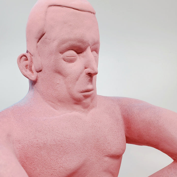 Holding Back I - large ceramic two-sided sculpture of a figure biting their tongue, with blue and pink gouache paint.