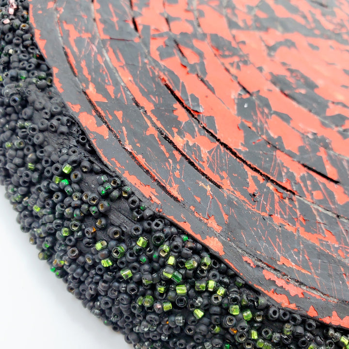 Red & Black: Mixed media wall sculpture constructed with a corrugated cardboard base. It is painted with acrylics, and adorned with glass beads.