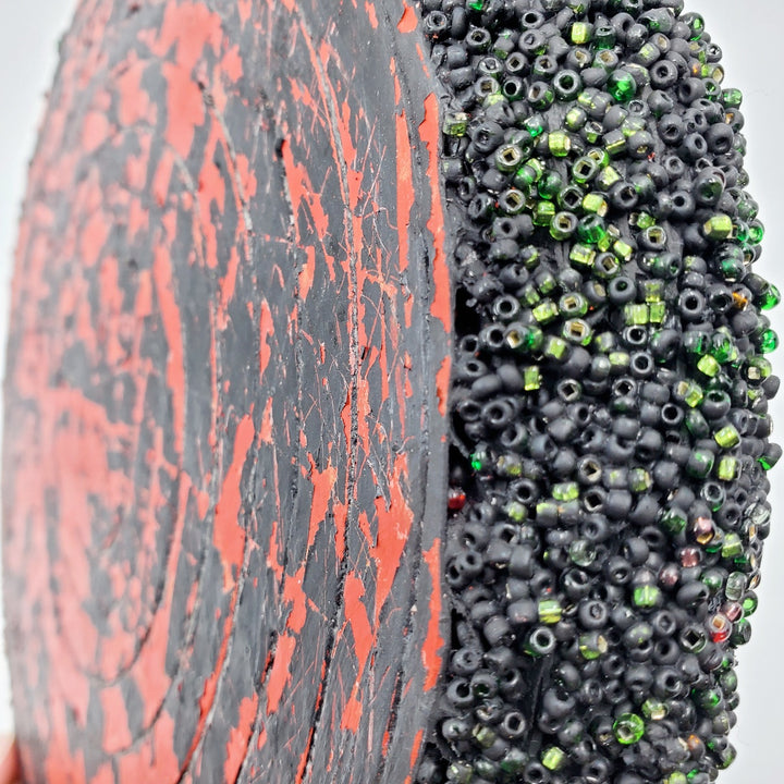 Red & Black: Mixed media wall sculpture constructed with a corrugated cardboard base. It is painted with acrylics, and adorned with glass beads.