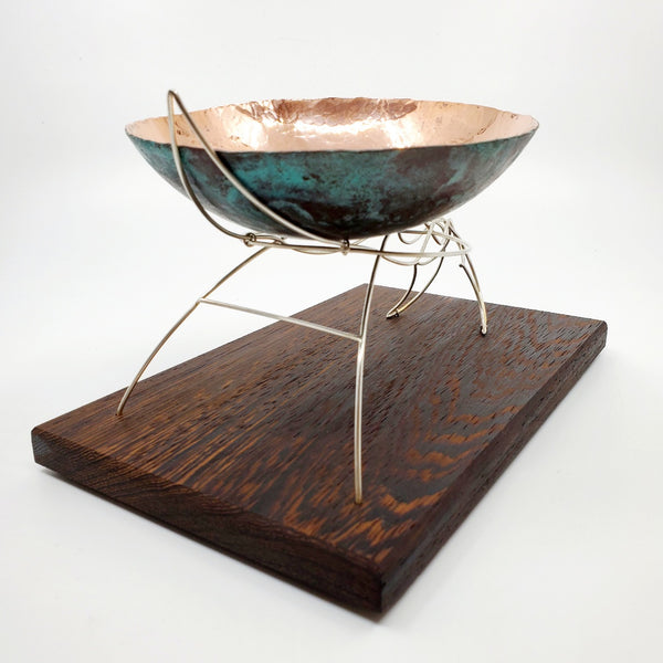 Continuity - "The unbroken and consistent existence." A copper vessel rests atop a sterling silver stand on a wenge wood base.