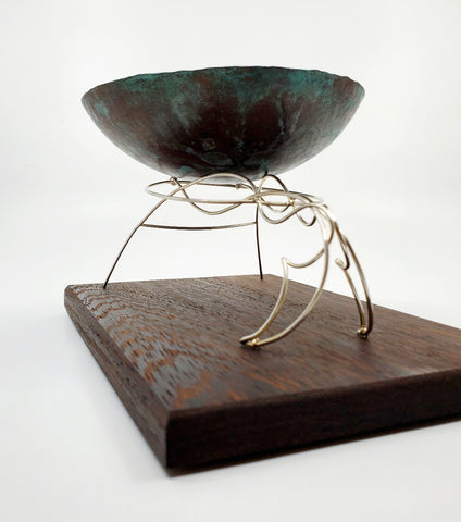 Continuity - "The unbroken and consistent existence." A copper vessel rests atop a sterling silver stand on a wenge wood base.