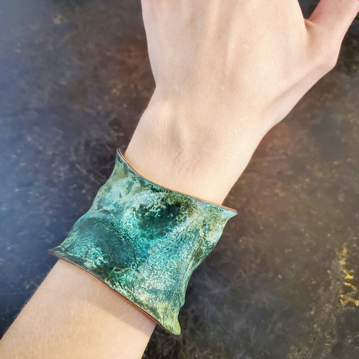 Hand formed copper cuff with sterling silver plate, chased and patinated.