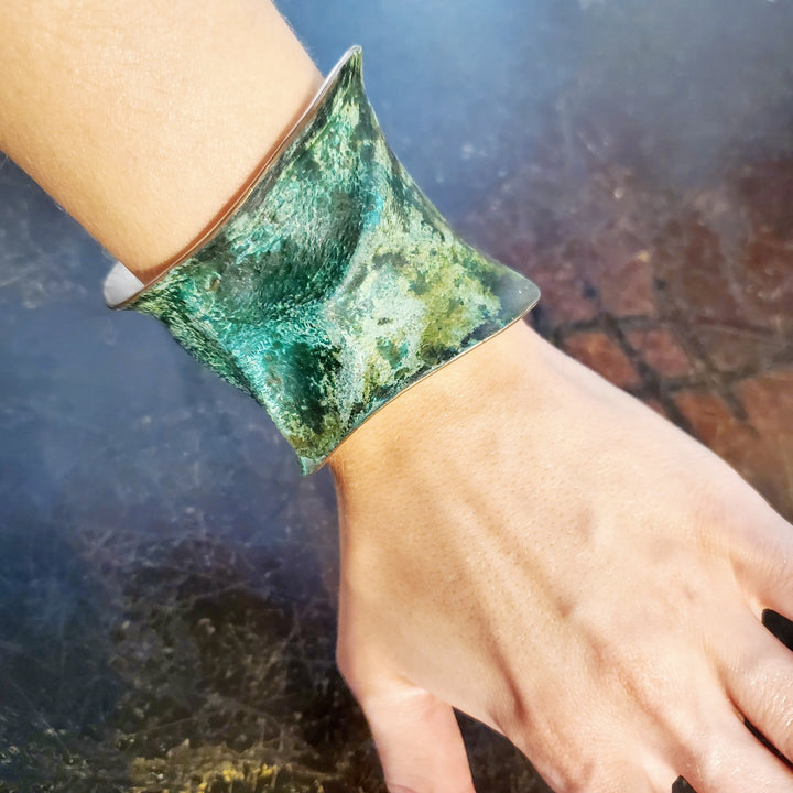 Hand formed copper cuff with sterling silver plate, chased and patinated.