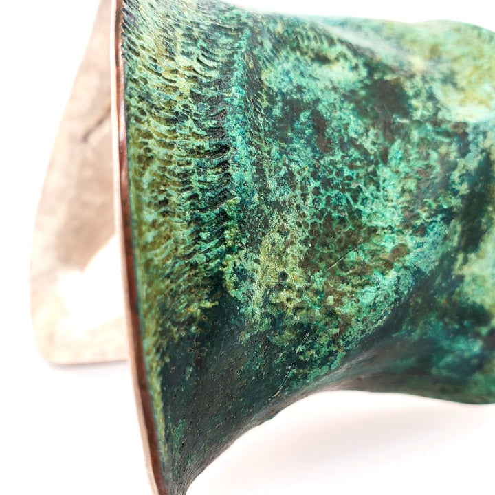 Hand formed copper cuff with sterling silver plate, chased and patinated.