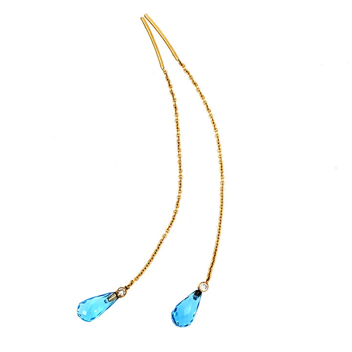 18k yellow gold earrings with blue topaz and single cut diamond pendants. 
