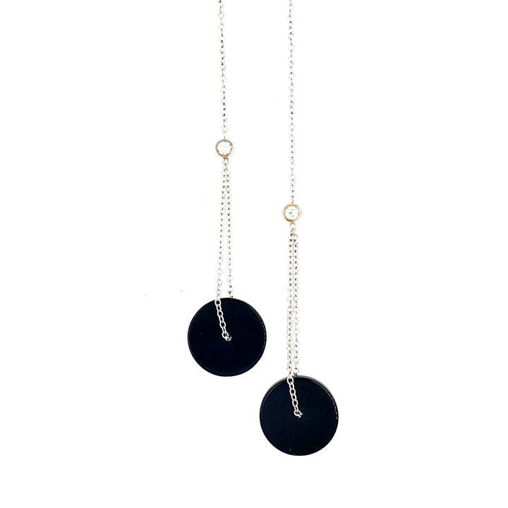 Dangle earrings with 18k white gold chain, onyx pendants, and diamond accents. 