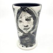 Medium ceramic vessel - 3. Hand painted porcelain vessel. Black glaze has been applied in careful layers to depict faces and patterns. 10 x 10 x 18 cm.