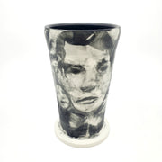 Medium ceramic vessel - 3. Hand painted porcelain vessel. Black glaze has been applied in careful layers to depict faces and patterns. 10 x 10 x 18 cm.