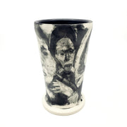 Medium ceramic vessel - 3. Hand painted porcelain vessel. Black glaze has been applied in careful layers to depict faces and patterns. 10 x 10 x 18 cm.