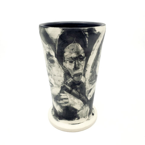 Medium ceramic vessel - 3. Hand painted porcelain vessel. Black glaze has been applied in careful layers to depict faces and patterns. 10 x 10 x 18 cm.