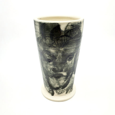Medium ceramic vessel - 2. Hand painted porcelain vessel. Black glaze has been applied in careful layers to depict faces and patterns. 10 x 10 x 18 cm.