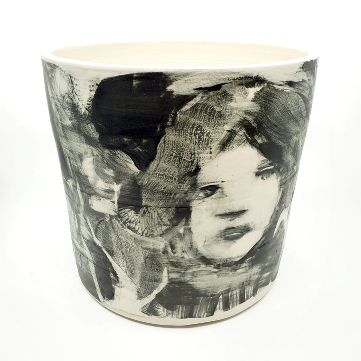 Large ceramic vessel - 2. Hand painted porcelain vessel. Black glaze has been applied in careful layers to depict faces and patterns. 25 x 25 x 23 cm.