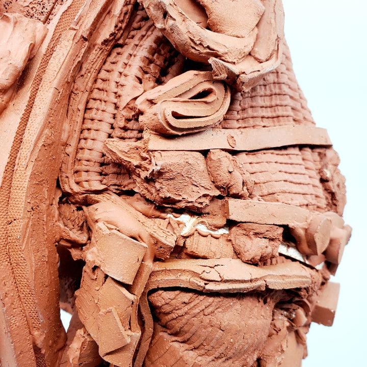 Terra Cotta Small Heads series - 3. Ceramic bust sculpture created by building up layers and layers of red clay. This bust measures 21 x 17 x 49 cm.