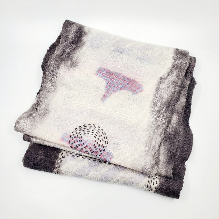 Light grey infinity scarf, created with hand-dyed silk and merino wool with recycled materials. 