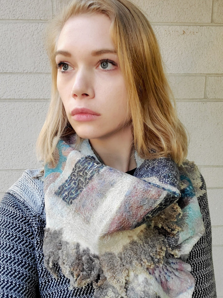 Long and delicate ivory scarf with green and blue swatches, created with hand-dyed silk and merino wool with recycled materials. 