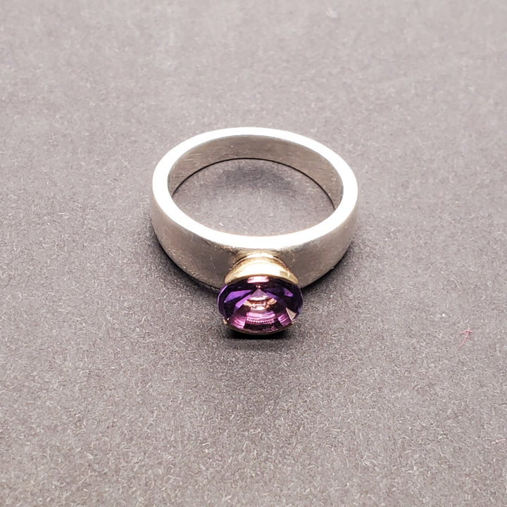 Moderna Round Solitaire ring with a radiant modern fancy cut round 7mm amethyst set in 14k yellow gold. 