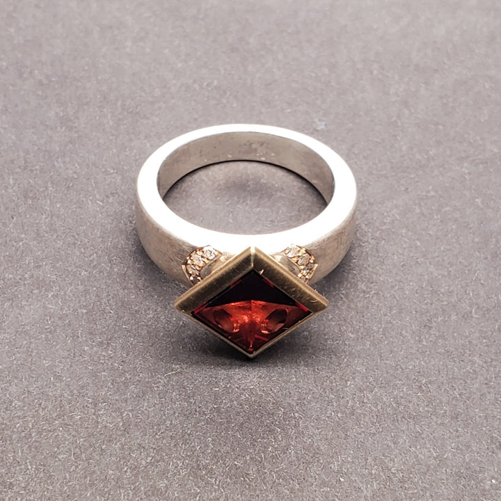 Moderna Square ring with a radiant modern fancy cut square 8mm pyrope garnet set in 14k yellow gold.
