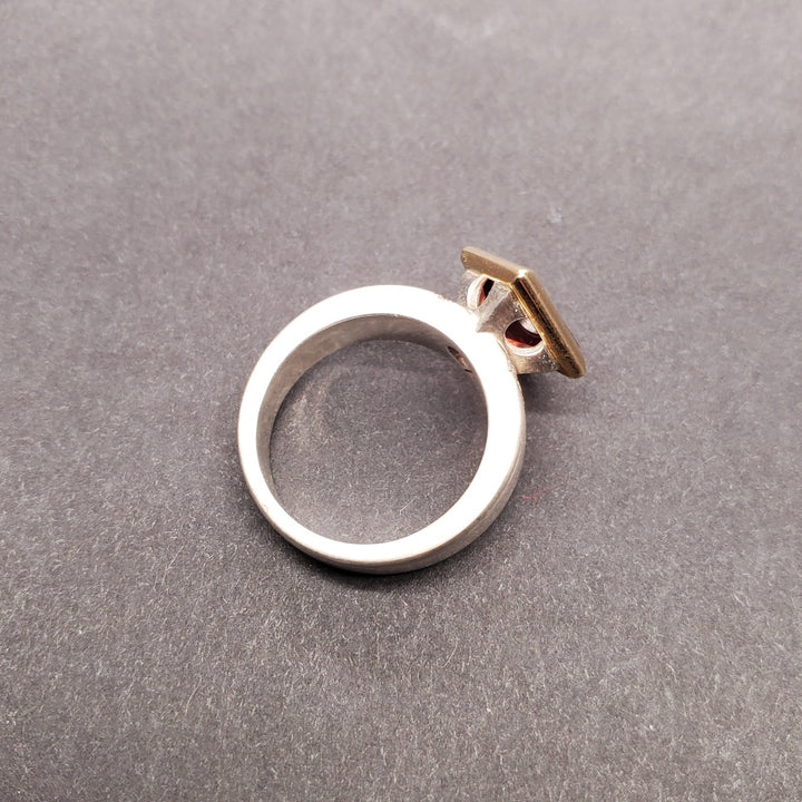 Moderna Square ring with a radiant modern fancy cut square 8mm pyrope garnet set in 14k yellow gold.