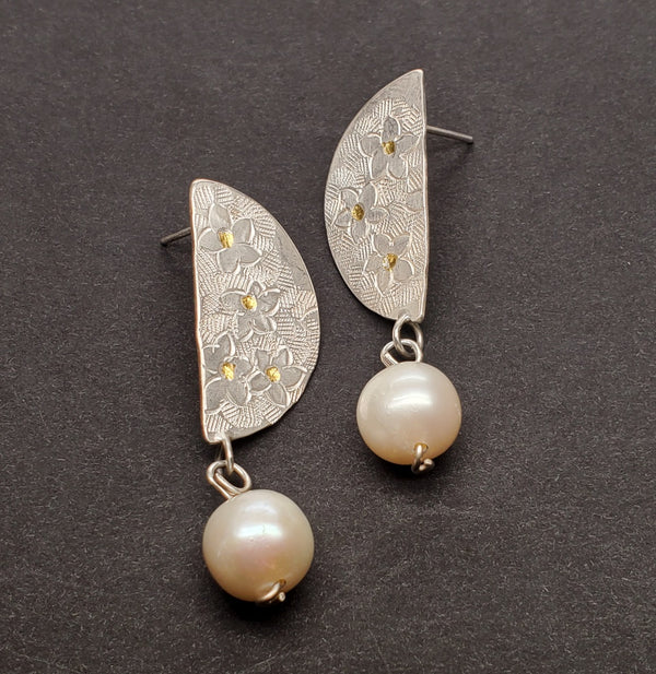 Hand-tooled fine silver stud earrings, with keum-boo gold (24k) worked into the surface. 10mm freshwater pearls hang from the flower-patterned semi-circles.