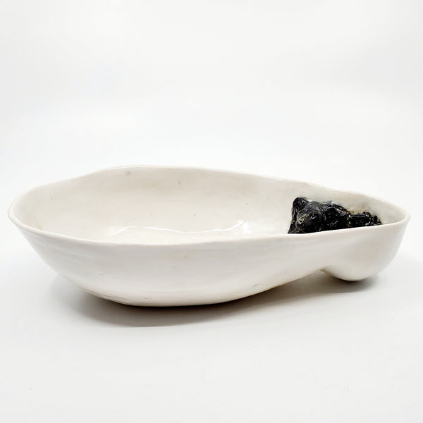 Multi-fired porcelain dish depicting a resting black bear. 