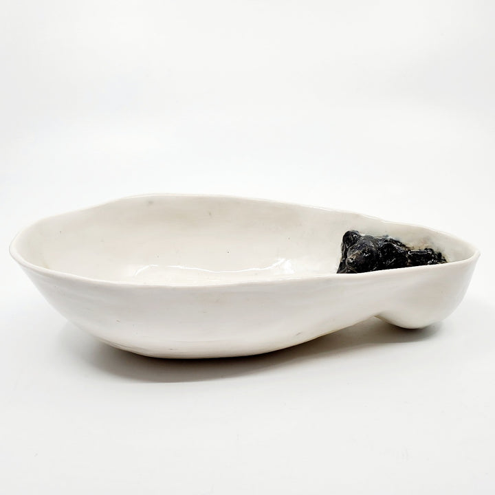 Multi-fired porcelain dish depicting a resting black bear. 