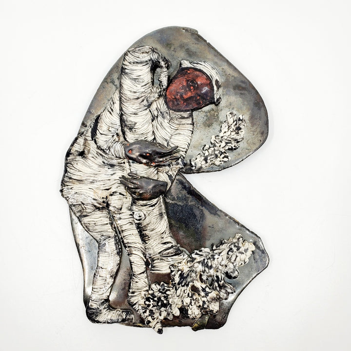 Figure with Tree : multi-fired porcelain wall sculpture of a figure with a felled tree.
