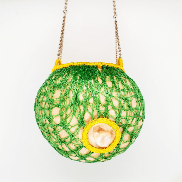 Les fruits #3, pendant of porcelain, silver, gold leaf, and embroidery thread. 