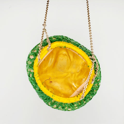 Les fruits #3, pendant of porcelain, silver, gold leaf, and embroidery thread. 