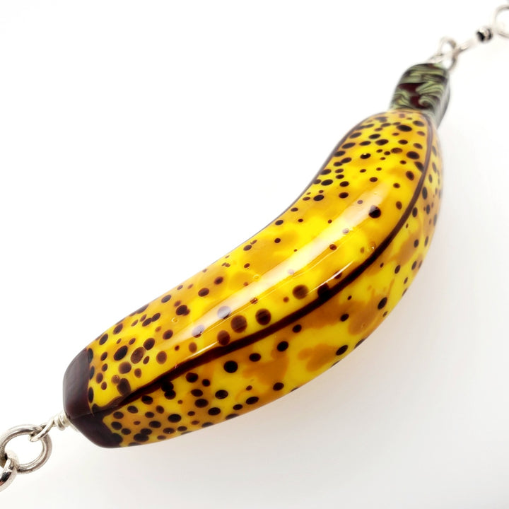 Necklace with flame-worked glass banana and sterling silver chain. Banana is approx 8 x 2 x 2cm.