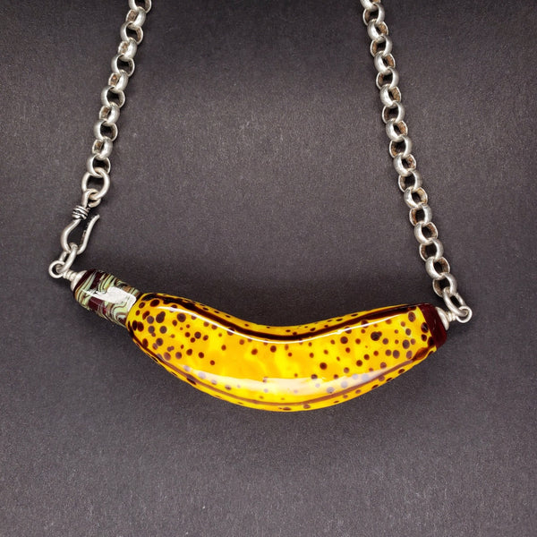 Necklace with flame-worked glass banana and sterling silver chain. Banana is approx 8 x 2 x 2cm.