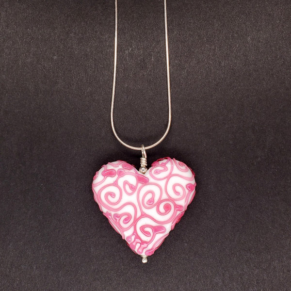 Gingerbread Heart glass pendant in pink on a 16" sterling silver snake chain.  Measures approx. 4 x 4 x 1 cm