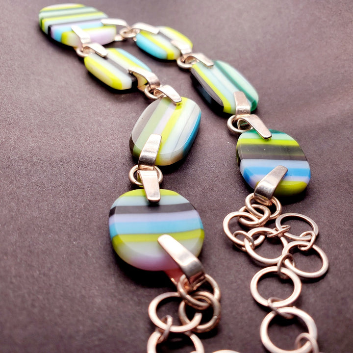 Green and blue striped glass necklace on a 20" sterling silver chain.