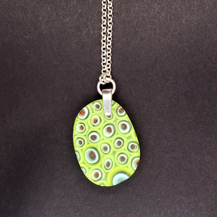 Oval green glass pendant made from kilnformed glass on a 30" sterling silver chain.