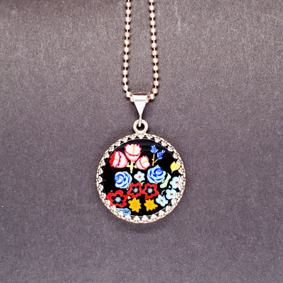 Botanical murrine glass pendant on a sterling silver chain.