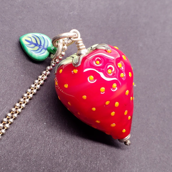  Strawberry Pendant made from flameworked glass on a 28" sterling silver chain.