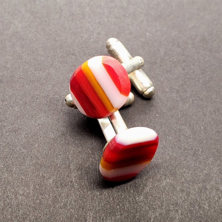 Striped red cufflinks of flame-worked glass.