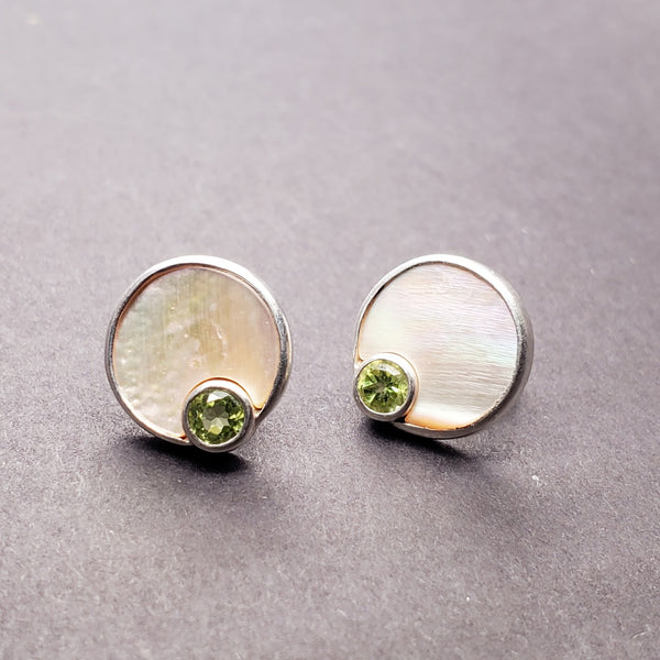 Sterling silver stud earrings embellished with peridot and mother of pearl. 